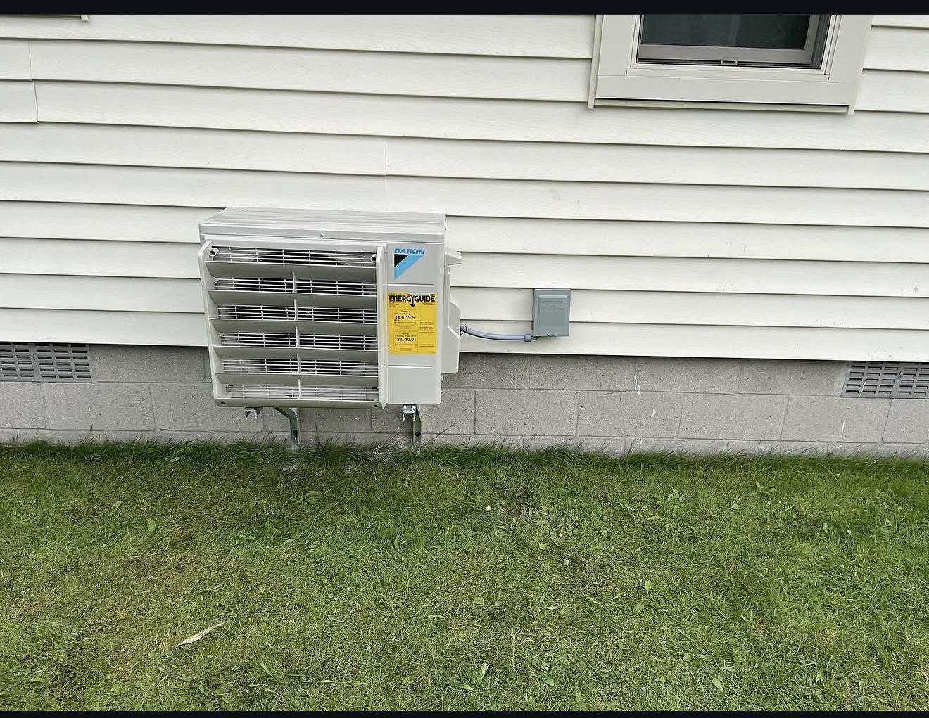 Outdoor ductless condenser installed beside a home