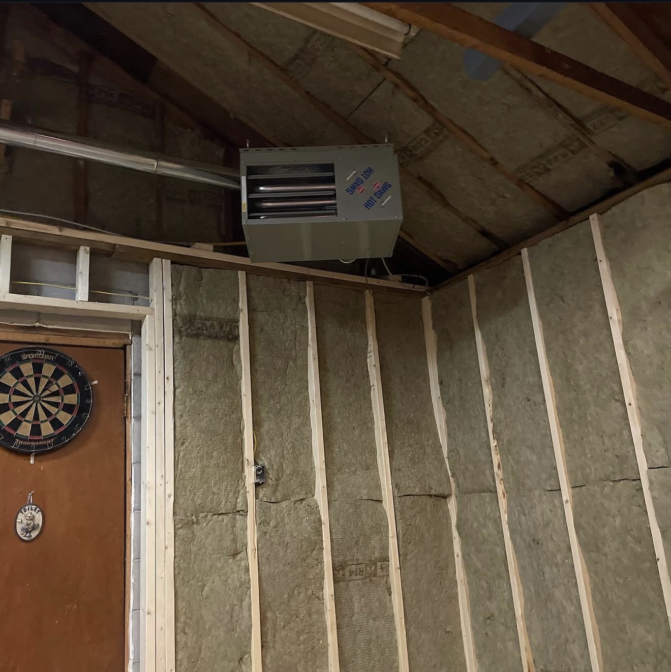 Ductless unit and utility lines installed in a workshop